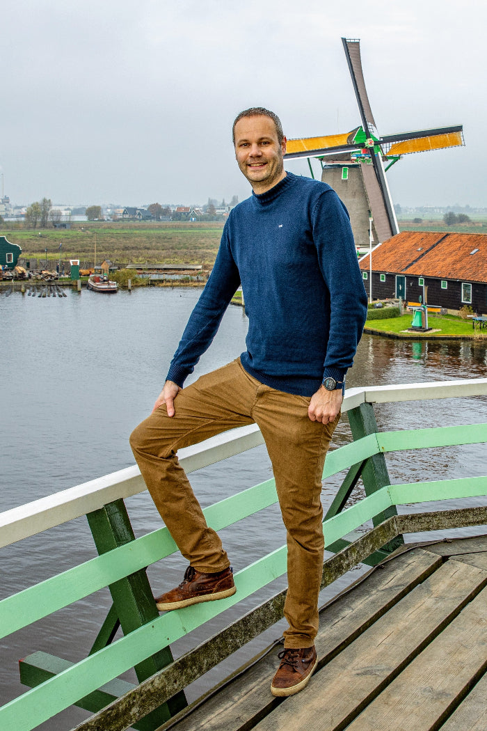 Sander standing in front of a Dutch windmill