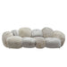 Beige PTMD Curvae polyester bank met een speels, gewatteerd design van 109x238 cm.