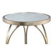 Ronde goudkleurige bijzettafel Rikka van PTMD met een ijzeren frame en glazen blad, 40 cm diameter.