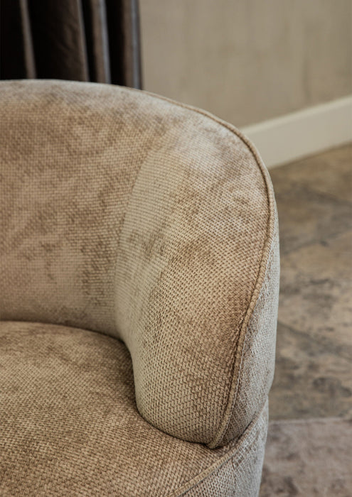 Beige fauteuil Filou van PTMD met gestructureerde polyester bekleding en een modern, rond design.
