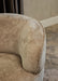 Beige fauteuil Filou van PTMD met gestructureerde polyester bekleding en een modern, rond design.