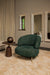 Olijfgroene fauteuil Franklyn van PTMD met polyester bekleding en slank metalen onderstel in een modern interieur.