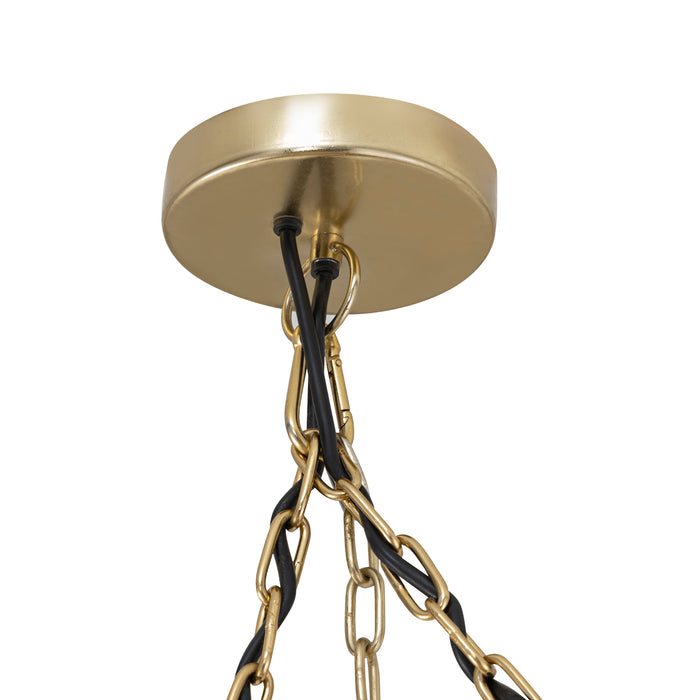 Gouden plafondkap van de PTMD Wilco hanglamp met bijpassende metalen kettingen en zwarte stroomkabels.