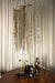 Grote PTMD Wilco hanglamp van messingkleurig gegoten aluminium met een decoratief design van hangende metalen kettingen.