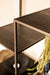 Zwarte PTMD vakkenkast van ijzer met houten legplanken, 40x110 cm, in een modern industrieel design.